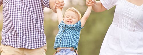 Batesburg Insurance Agency | Auto Home Business | laughing child holding parents' hands as they swing him